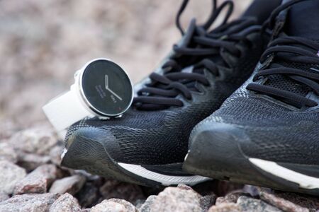 Sport watch for crossfit and triathlon on the running shoes. Smart watch for tracking daily activity and strength trainingの写真素材