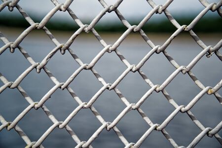 Mesh cage fence with wire behind, marine concept.の写真素材