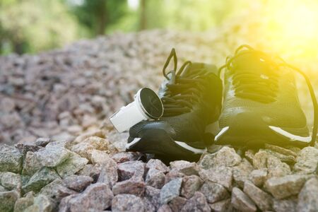 Sport watch for crossfit and triathlon on the running shoes. Smart watch for tracking daily activity and strength training. Sun beam lightsの写真素材