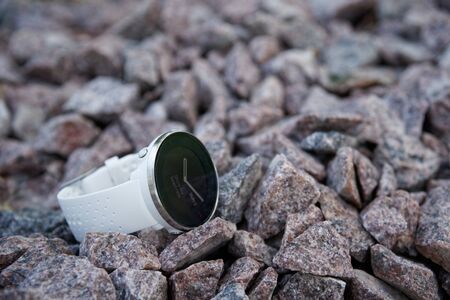 Sport watch for triathlon on the granite gravel. Smart watch for tracking daily activity and strength trainingの写真素材