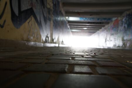 Pedestrian crossing tunnel, Dark and long underground passage with light.の写真素材