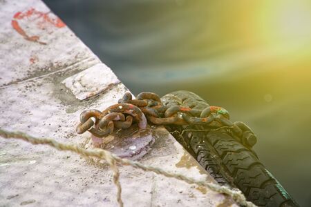 Boat chain and old tires for, mooring of ships on river.の写真素材
