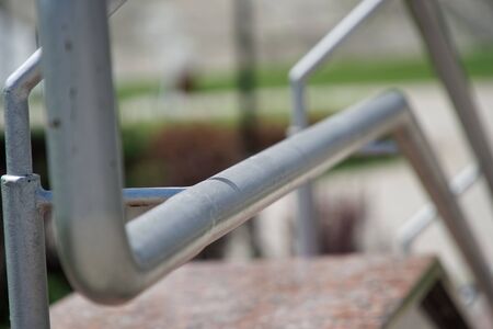 Metal handrails on crossing the road, close-up, shadows.の写真素材