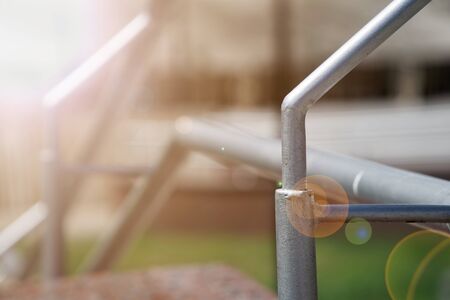 Metal handrails on crossing the road, close-up, shadows. Sun beam lights.の写真素材