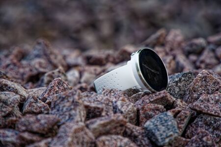 Sport watch for triathlon on the granite gravel. Smart watch for tracking daily activity and strength trainingの写真素材
