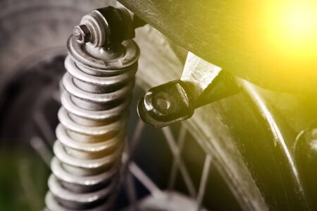 Old classic part of retro motocycle, close-up shock absorber.の写真素材
