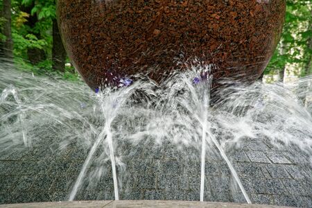 Stream of water from the granit fountainの写真素材