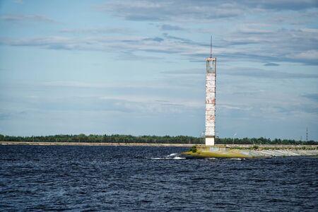 Lighthouse or old beacon under storm clouds.の写真素材