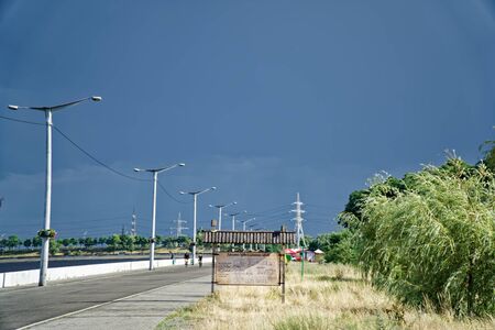Black sky over the green hill, before storm.の写真素材