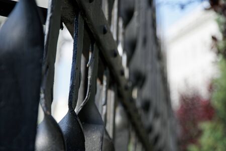 Long fence iron, metal fence, soft focus, low angle view.の写真素材