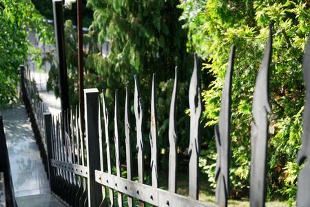 Long fence iron, metal fence, soft focus, low angle view.の写真素材