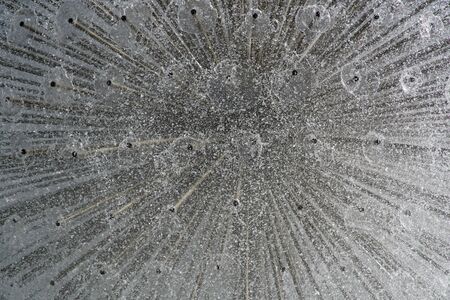 Fountain in the sun backlight. The fountains gushing sparkling water from pipe in park.の写真素材