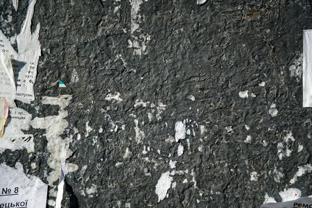 Torn poster, plastered wall with exposed brick wall.の写真素材