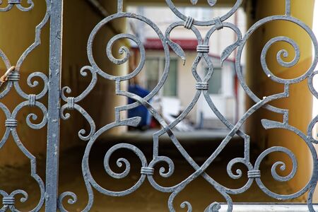 Old peaceful patio behind steel fence, soft focus, blured background.の写真素材