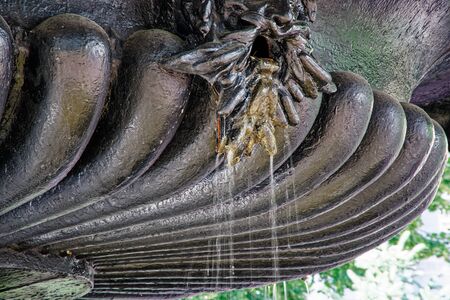 Fountain in the sun backlight. The fountains gushing sparkling water from pipe in park.の写真素材