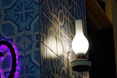 Decorative kerosene lamp in cafe. Gasoline lamp on wall indoor cafe.の写真素材