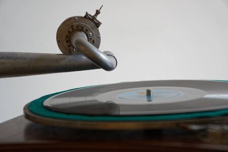Turntable, Old record player stylus on a rotating disc, vintage filtered, selective focus.
