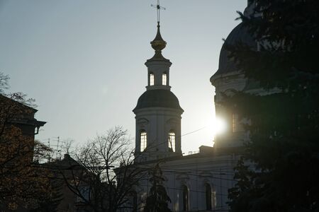 Part of ortodox church in front view with sun behind the clounds. The sun rays breaks through the...