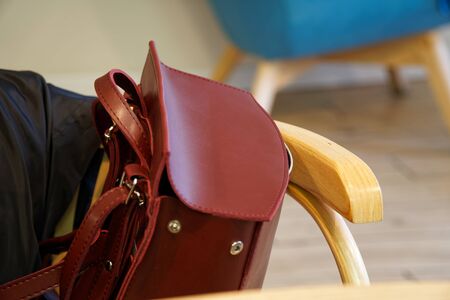 Fashionable beautiful part of leather red backpack. Warm color. Close up