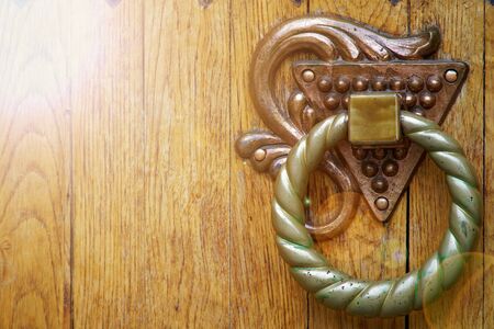 Doorknocker close-up, details of old wooden door.の写真素材