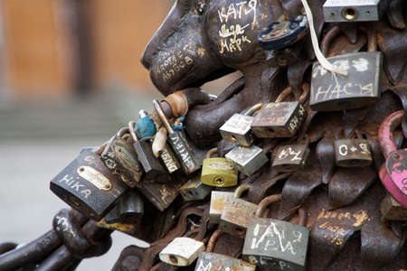 Love padlocks at rusty statue of bronze lion.のeditorial素材