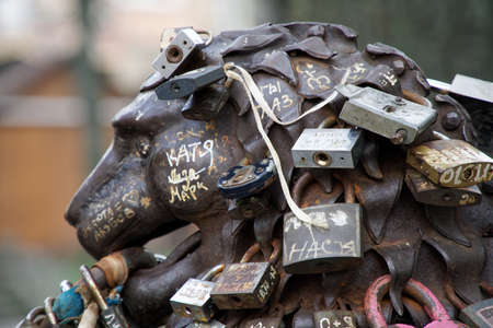 Love padlocks at rusty statue of bronze lion.のeditorial素材