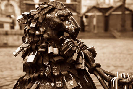 Love padlocks at rusty statue of bronze lion.のeditorial素材