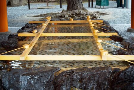 Purification pool outside a Japanese shrine. の写真素材