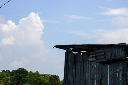 Old wooden house with blue sky and white cloud background, Thailand.の写真素材