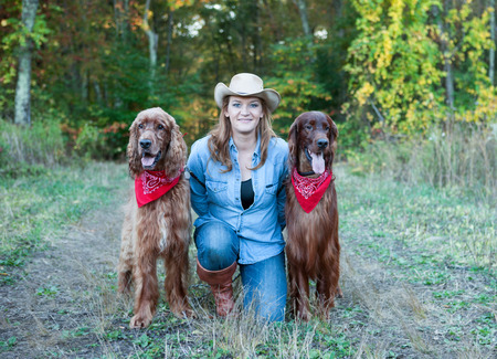 Woman with Irish Setter dogsの写真素材