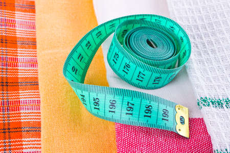 Tape-line and fabric samples close up at tailor's shopの写真素材