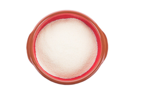 Ceramic plate with dry semolina isolated on whiteの写真素材