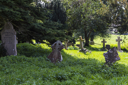 MILTON KEYNES, ENGLAND - APRIL 22, 2015: View at Holy Trinity Church churchyard with ancient graves...