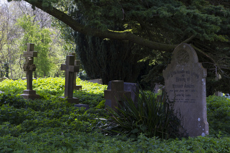MILTON KEYNES, ENGLAND - APRIL 22, 2015: View at Holy Trinity Church churchyard with ancient graves and tombs in Old Wolverton, UK.のeditorial素材