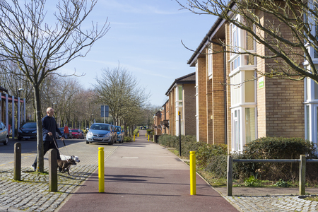 MILTON KEYNES, ENGLAND - MARCH 03, 2015: Sunny view at streets and residential buildings of Two Mile Ash district in spring day, United Kingdom.のeditorial素材