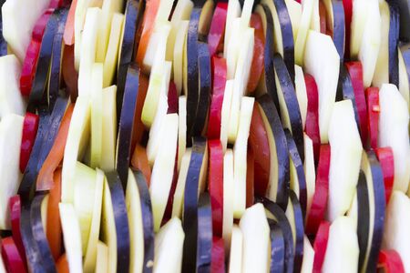 Sliced eggplants, marrows, potato and tomatoes close upの写真素材