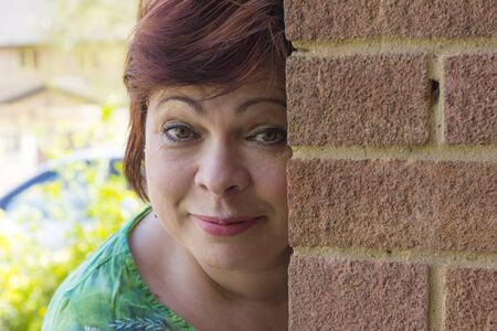 Relaxed mature female posing outdoors in summer dayの写真素材