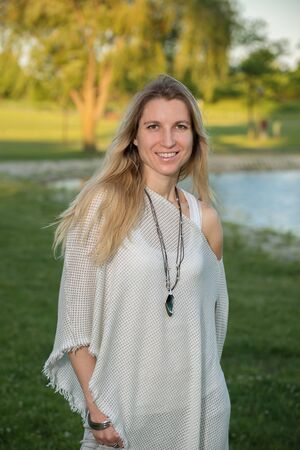 Portrait of a attractive young woman in park with blurred backgroundの写真素材