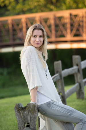 Portrait of a attractive young woman in park with blurred backgroundの写真素材
