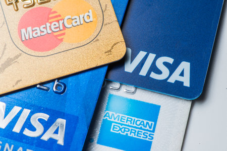 Close up of credit cards with MasterCard,Visa and American Express logos on white background,illustrative editorialのeditorial素材