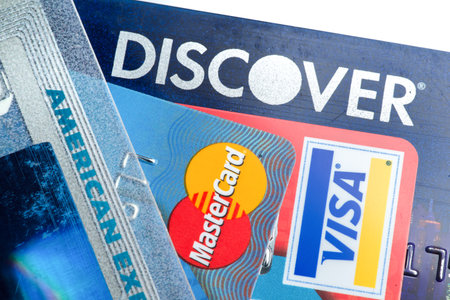 Close up of credit cards with Discover,American Express,visa and MasterCard logos on white background,illustrative editoriaのeditorial素材