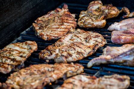 Delicious pork steaks with seasoning on the grillの写真素材