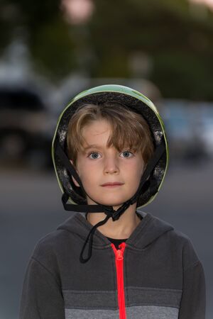 Portrait of a kid wearing a bicycle helmet incorrectlyの写真素材