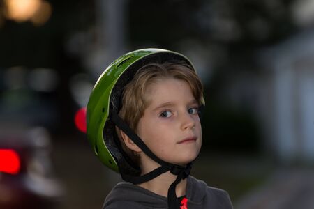 Portrait of a kid wearing a bicycle helmet incorrectly