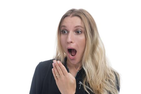 Portrait of a surprised woman with opened mouth and blond hair. Woman in shock, isolated against white backgroundの写真素材