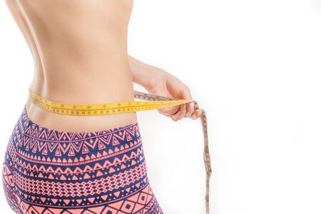 Fitness woman measuring her waist, weight lossの写真素材