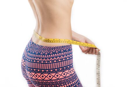 Fitness woman measuring her waist, weight lossの写真素材