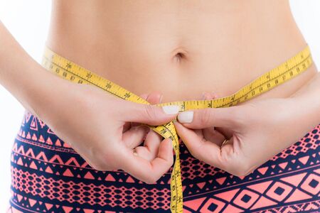 Fitness woman measuring her waist, weight lossの写真素材