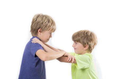 Two kids fighting, siblings, friends fight isolated on a white backgroundの写真素材