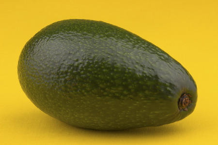 Avocado on yellow tablecloth.の写真素材
